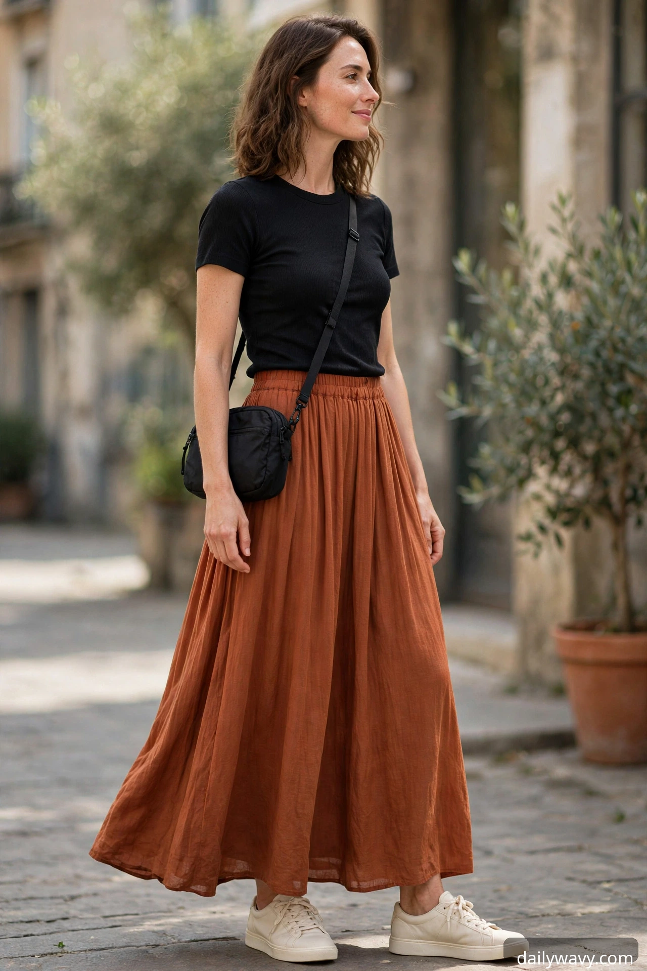 Black fitted top with a rust-colored long flowing skirt