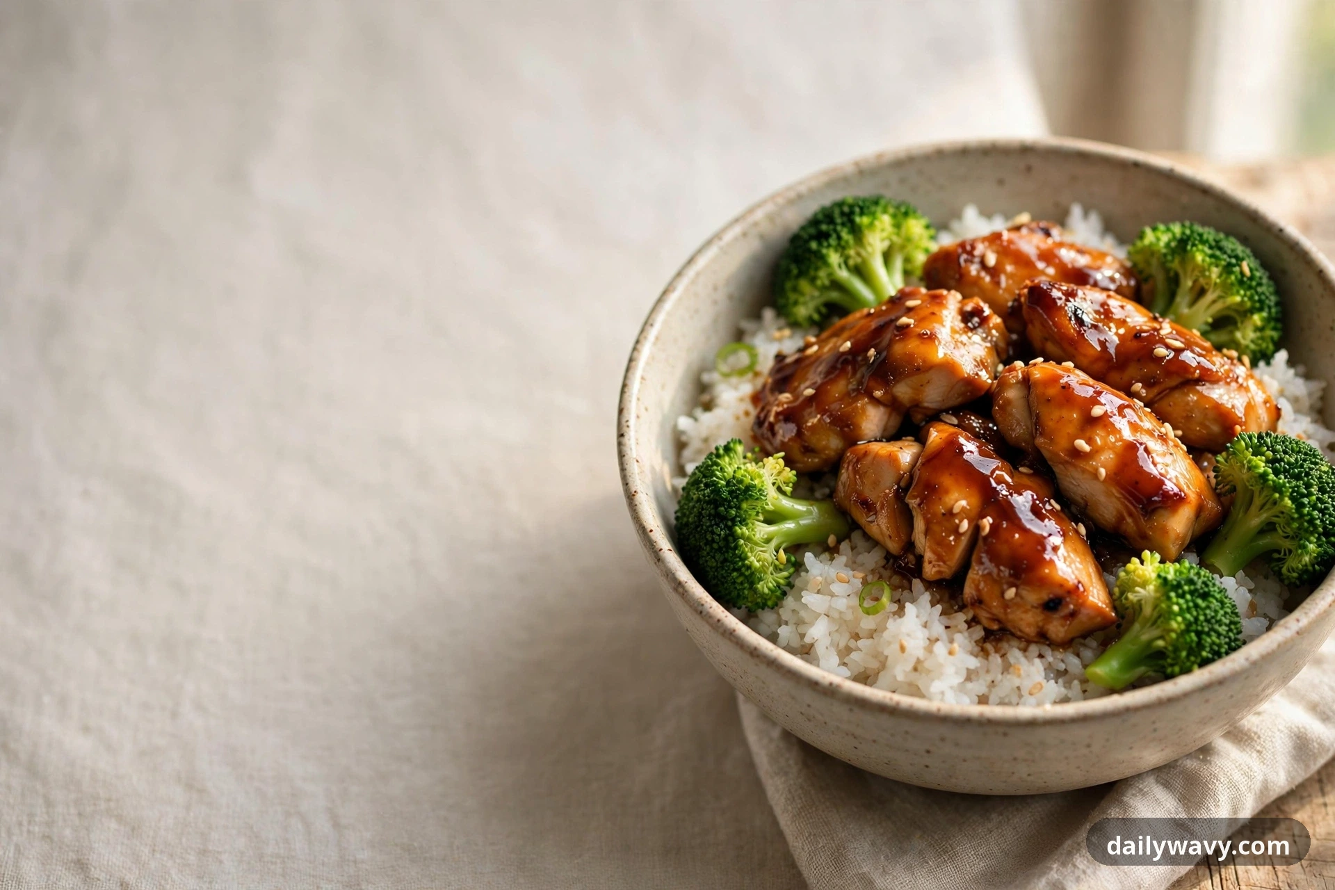 Chicken rice bowl with teriyaki glaze and broccoli, complete styled hero