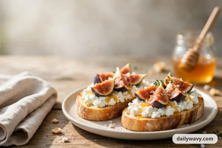 Wide view of two fig and honey cottage cheese toasts on a round plate, with a glass honey jar and dipper behind them and a linen napkin on a rustic wooden table.