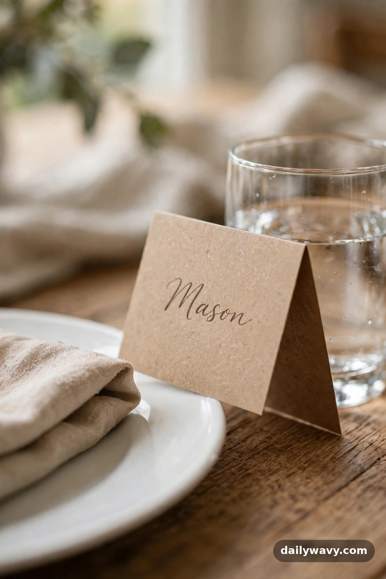 A handwritten place card at a dinner table place setting