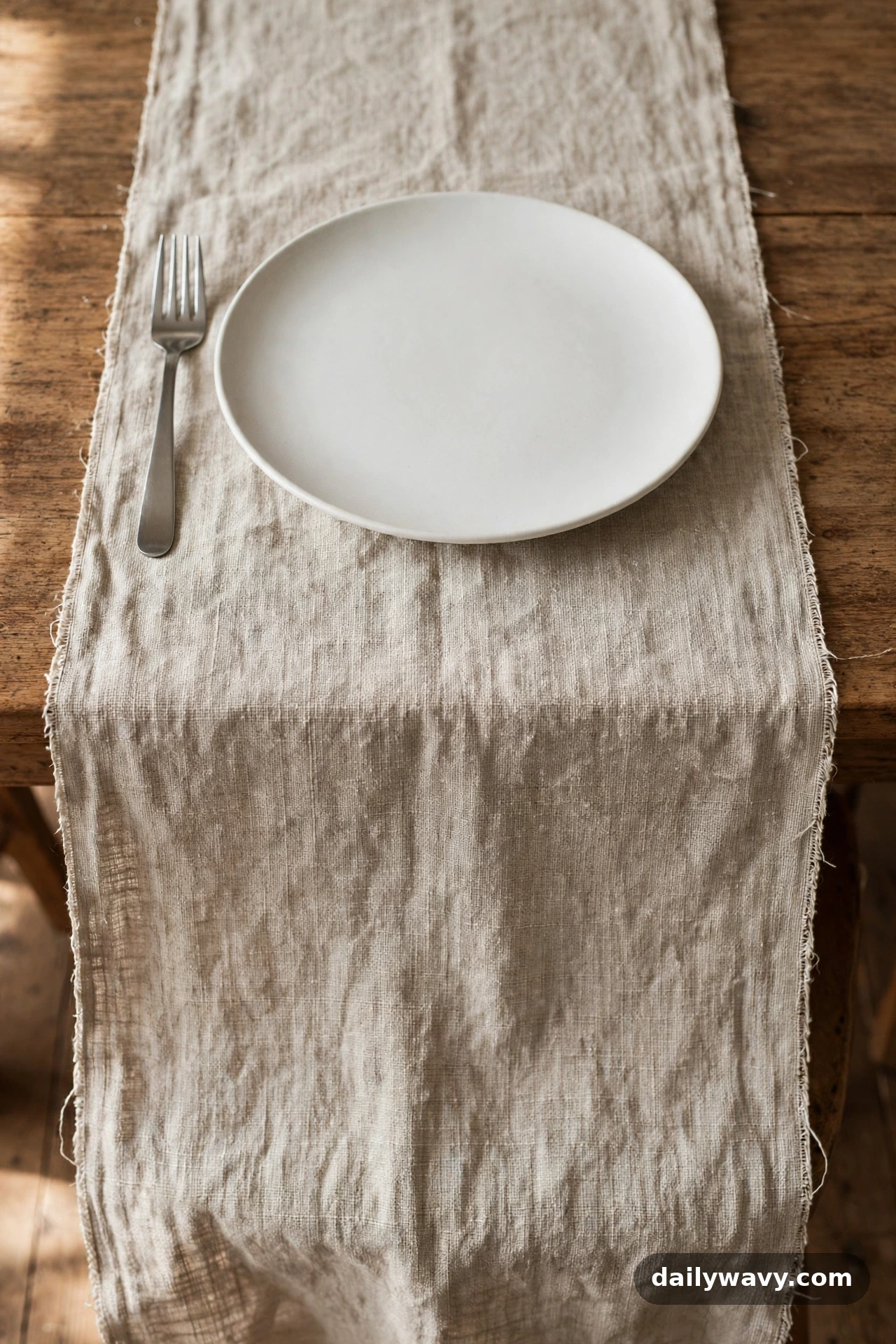 A folded fabric strip beneath each dinner table setting