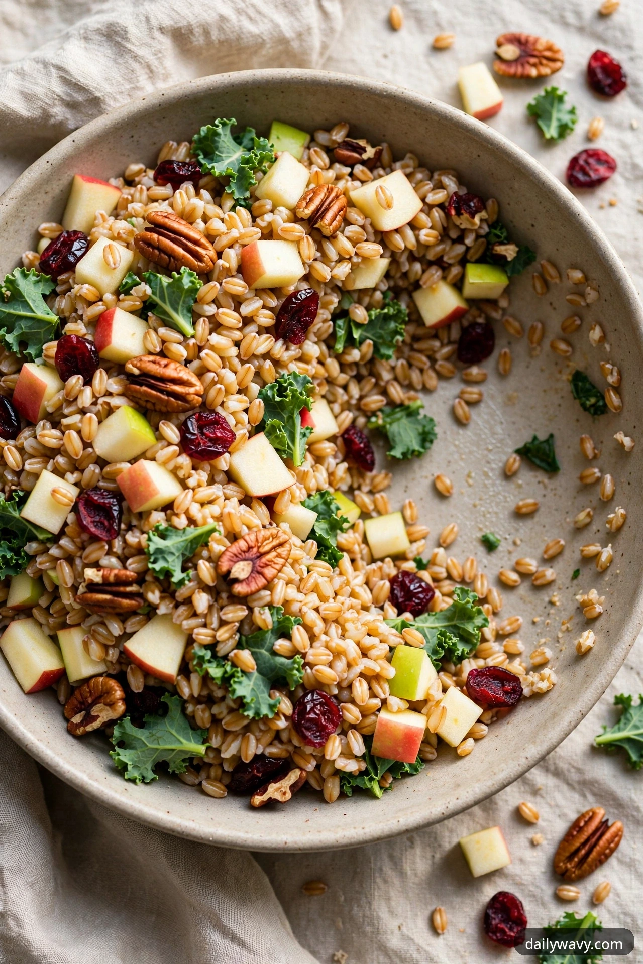 Farro salad with diced apples, toasted pecans, dried cranberries and baby kale