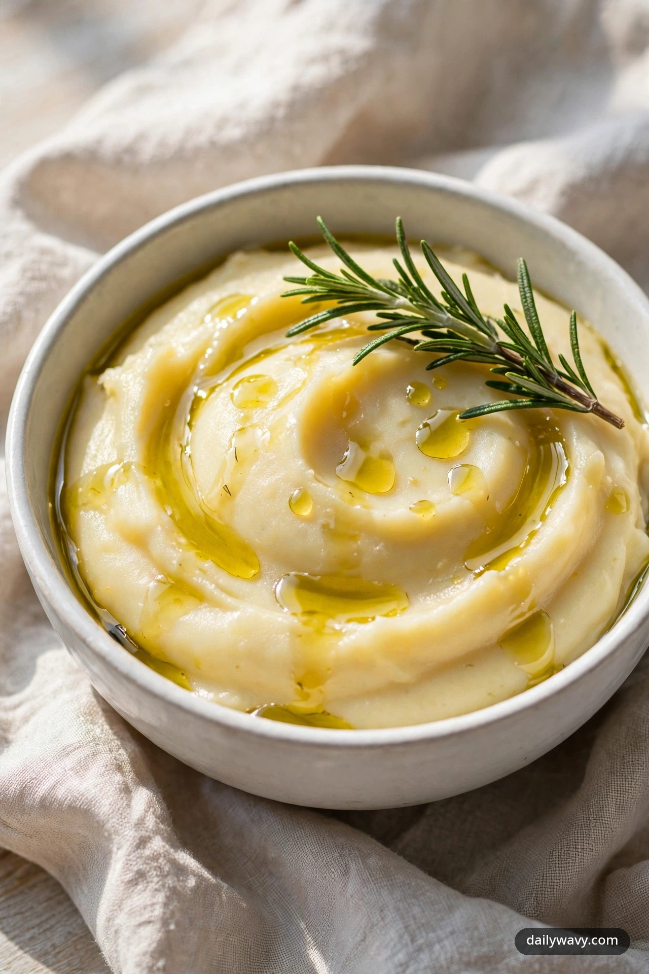 Mashed potatoes with rosemary and olive oil, fresh rosemary sprig on top