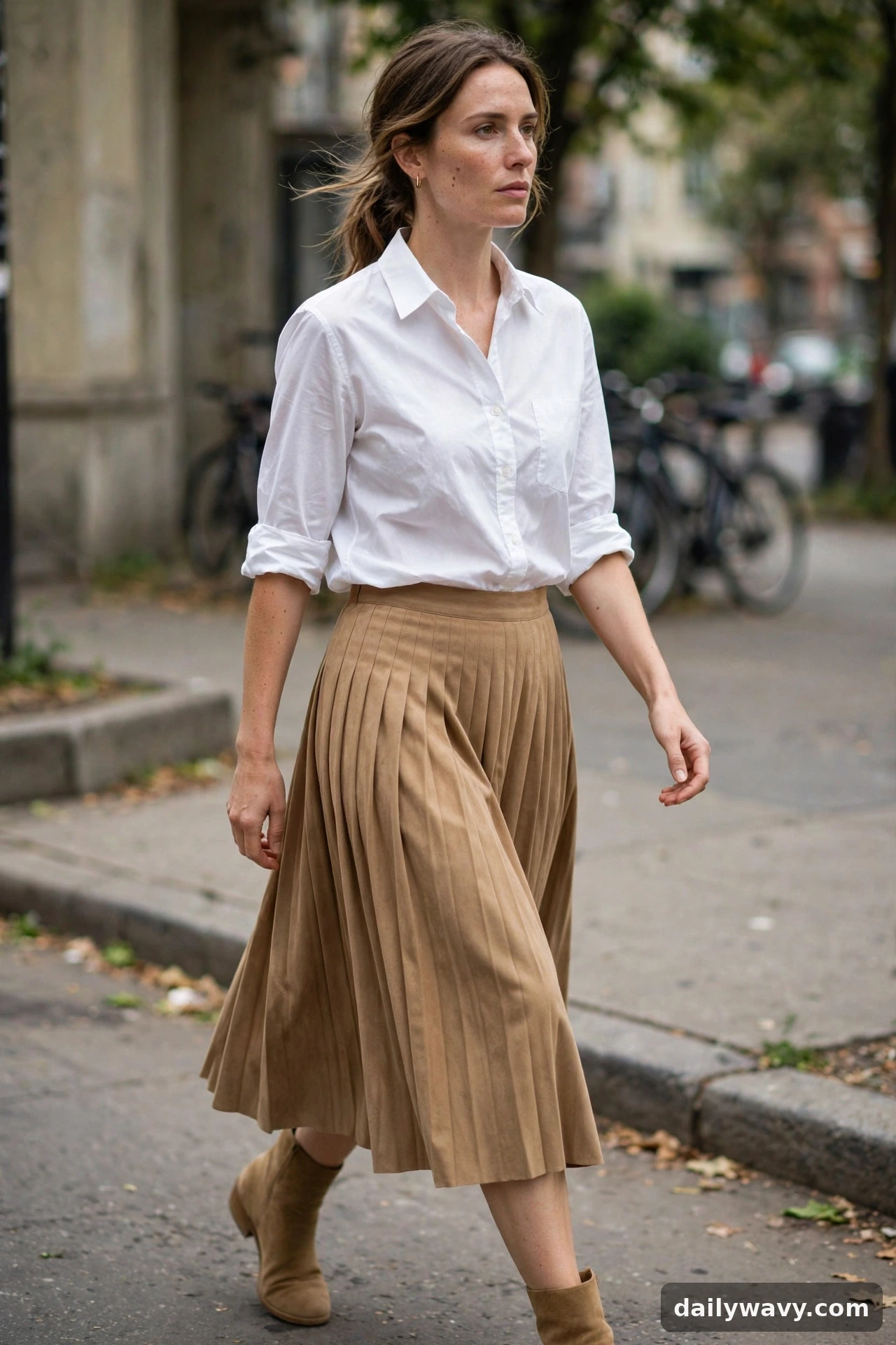 Adult wearing white shirt with a midi skirt for neutral capsule wardrobe outfits