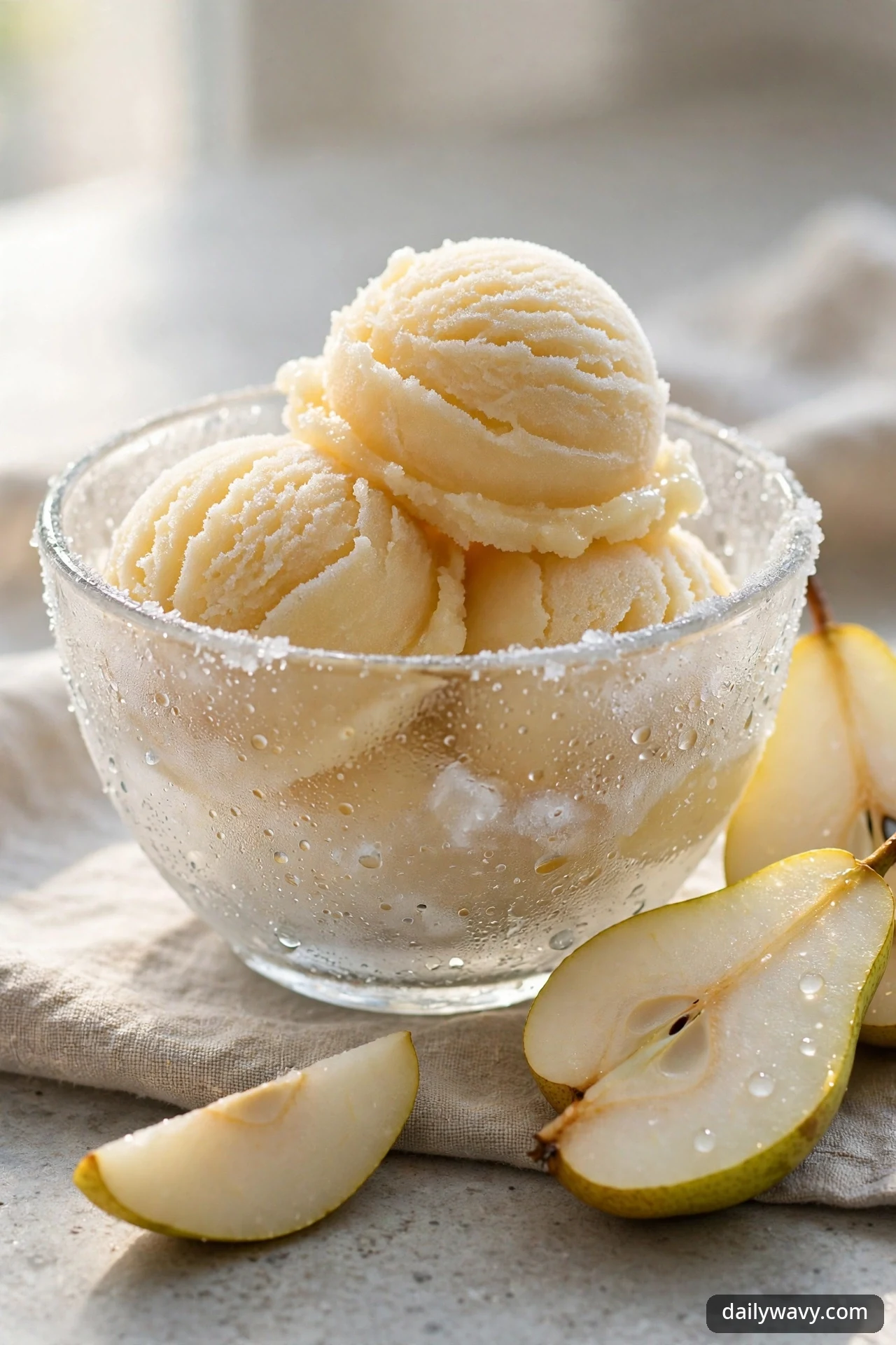 Scoops of pear sorbet in a chilled glass bowl
