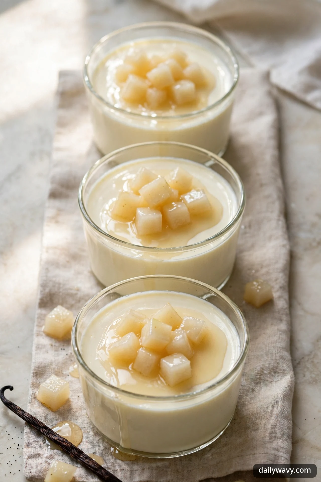 Vanilla panna cotta cups topped with poached diced pears