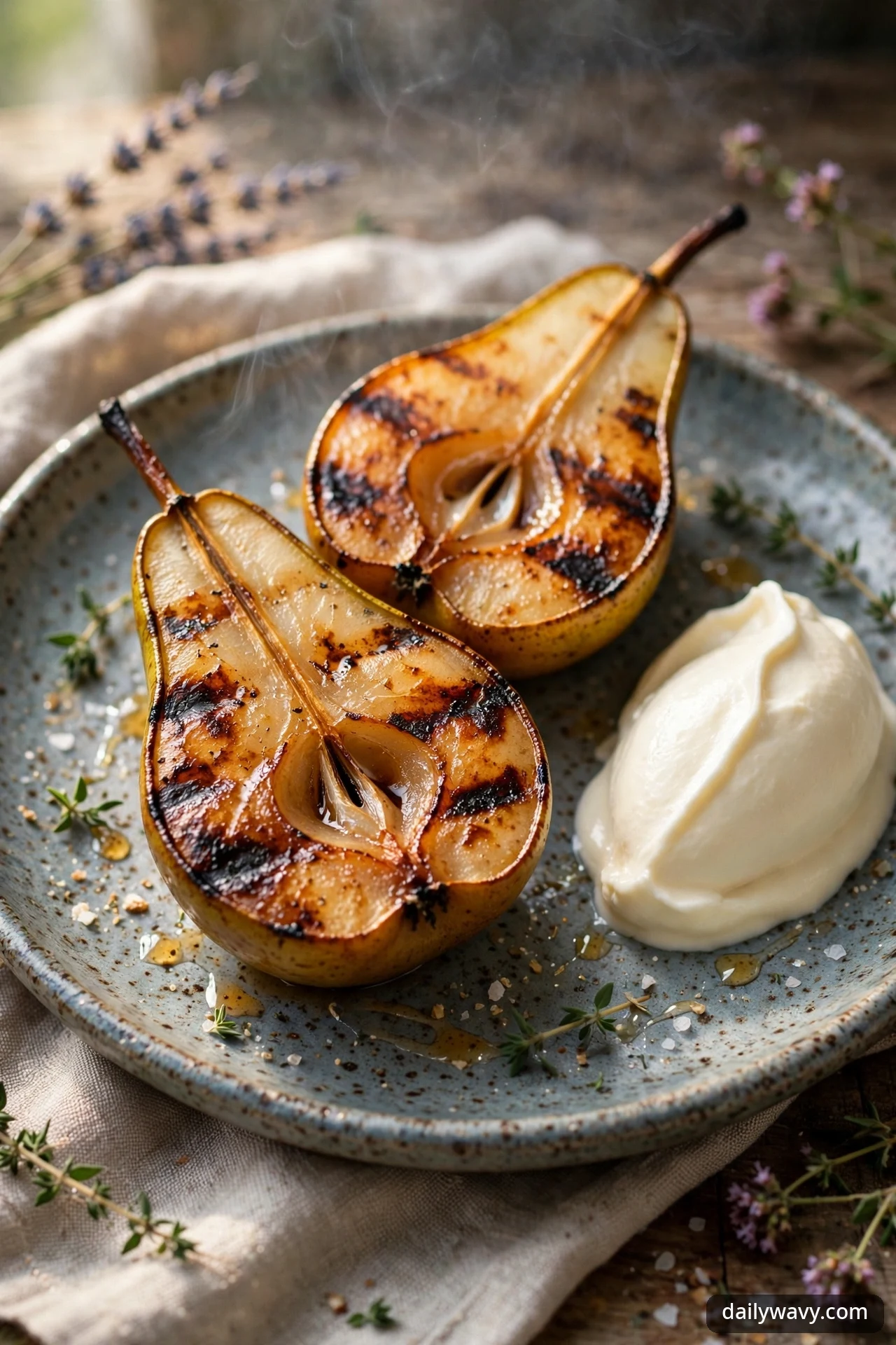 Grilled pear halves with char marks served with mascarpone cream