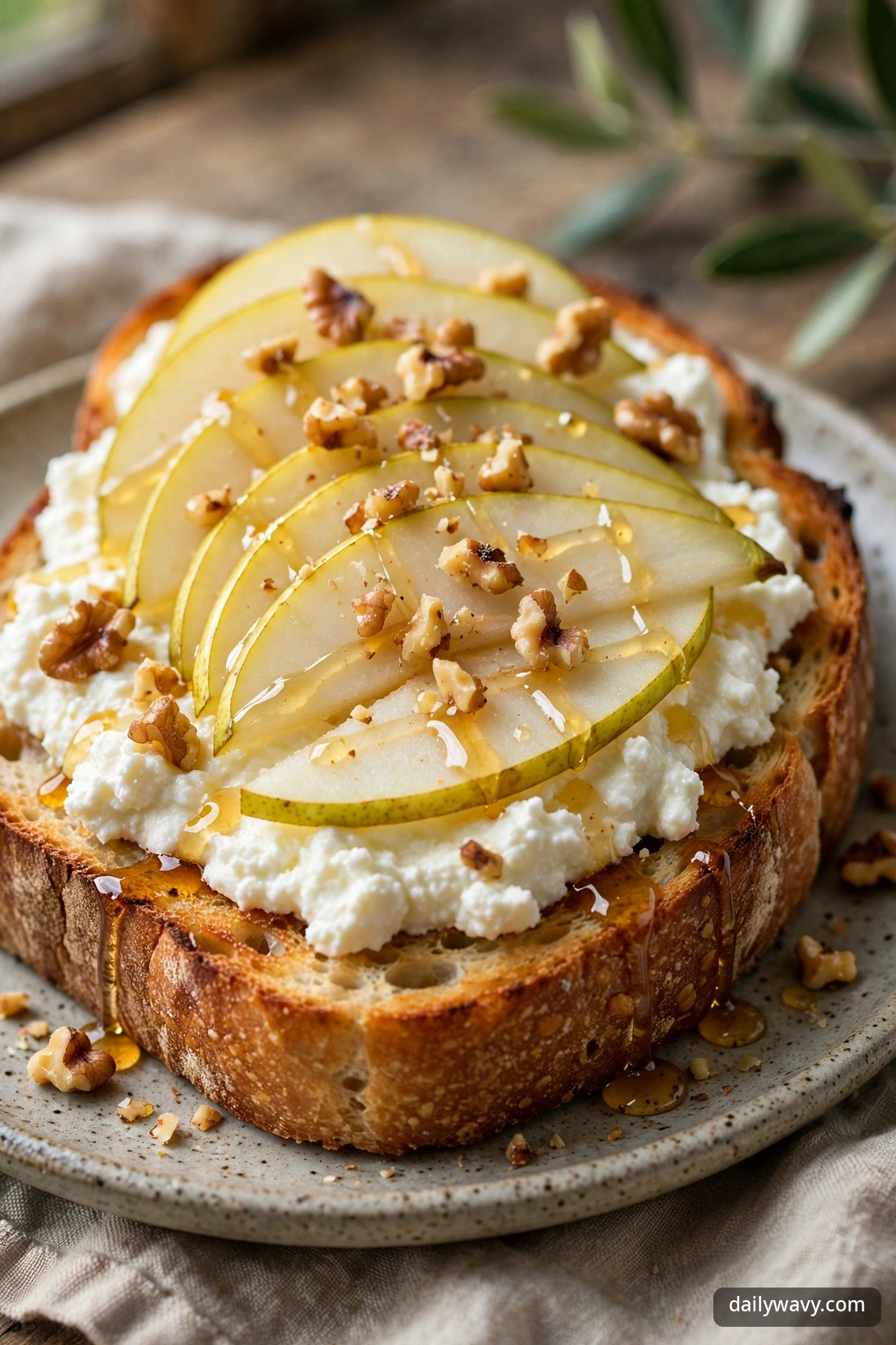 Ricotta toast with pear slices and toasted walnuts