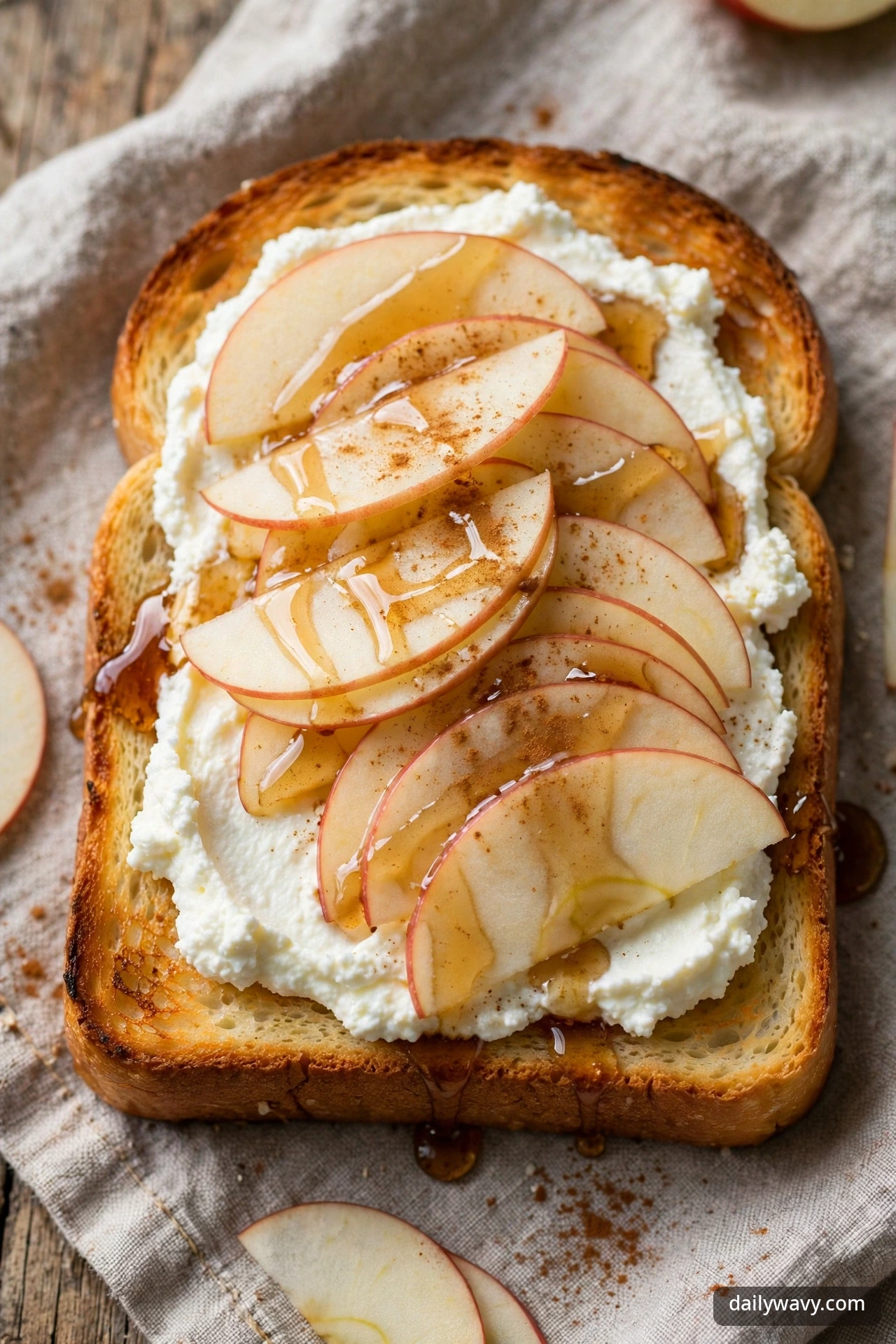 Ricotta toast with thin apple slices and maple syrup