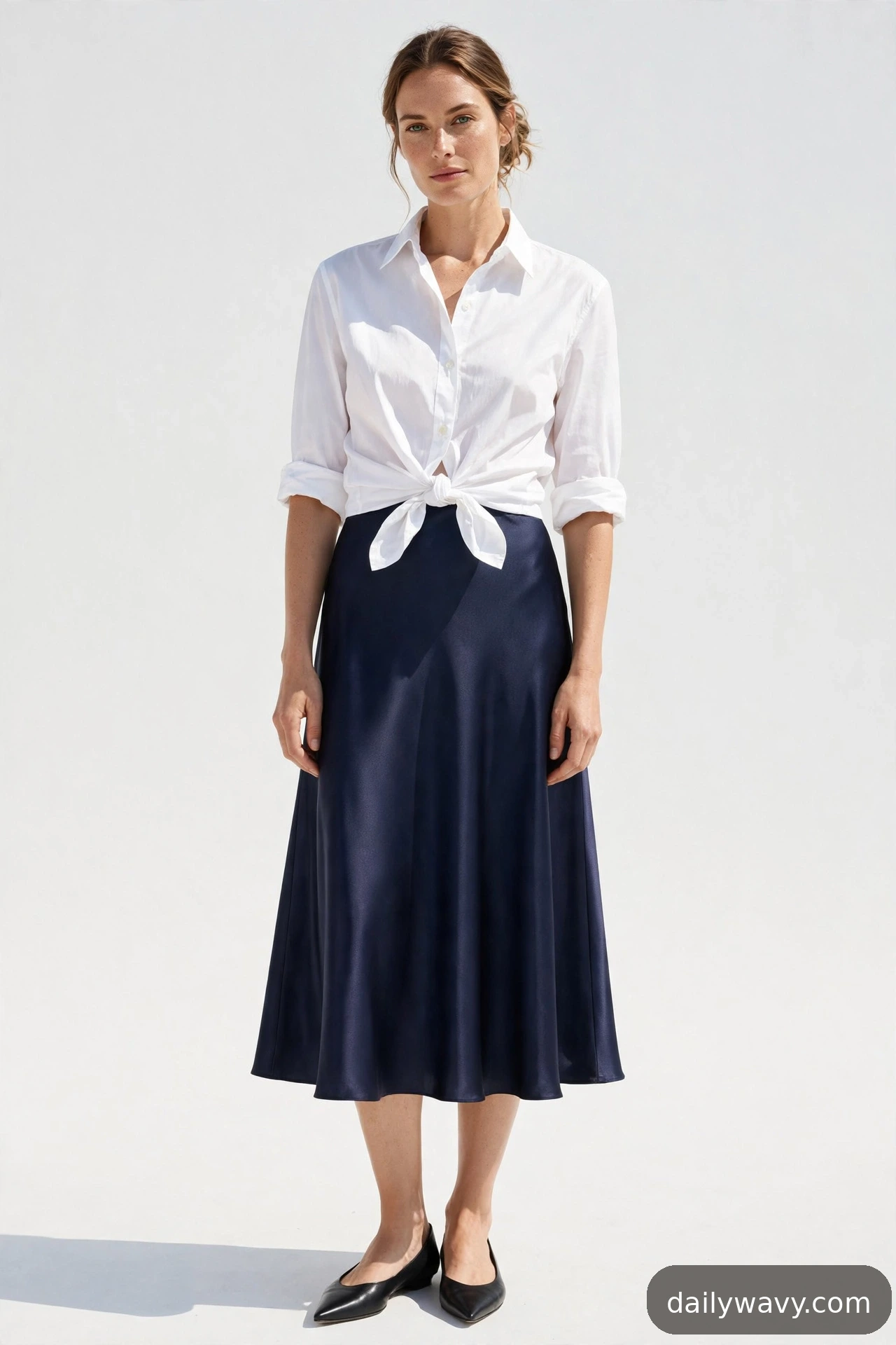 Adult wearing cotton shirt tied at the waist and flats for satin midi skirt outfits