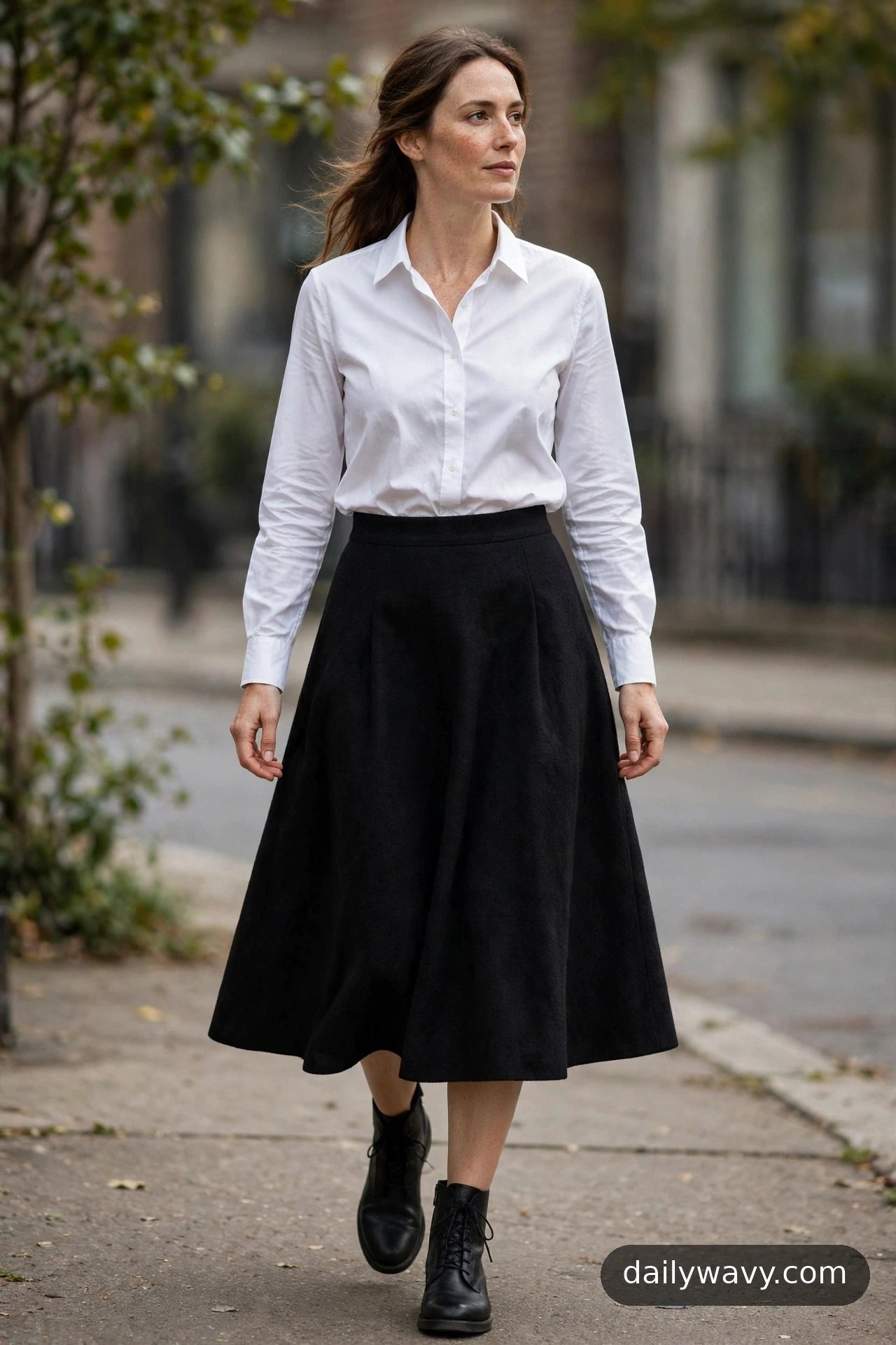 White button-down shirt with an A-line skirt and ankle boots